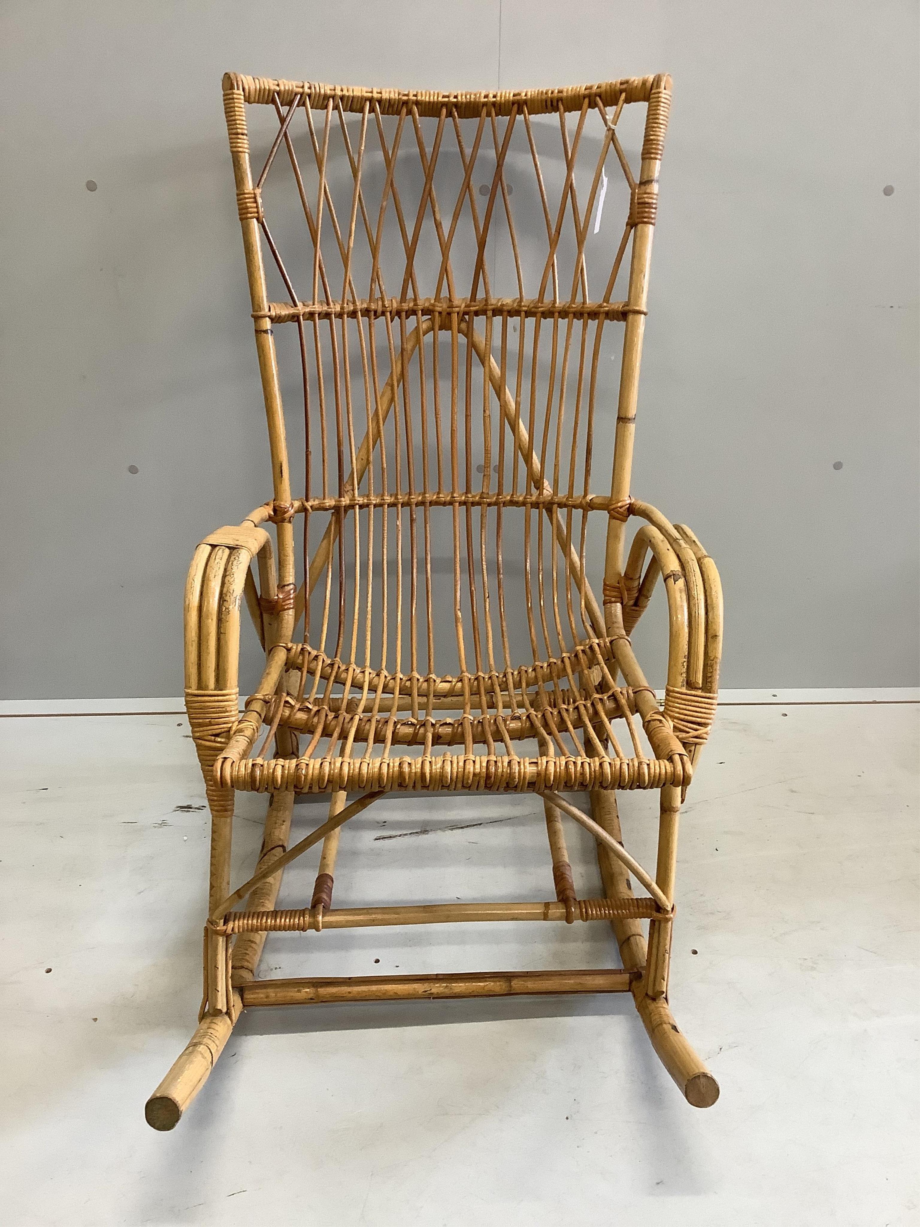 A vintage caned bamboo rocking chair, width 61cm, height 108cm. Condition - fair